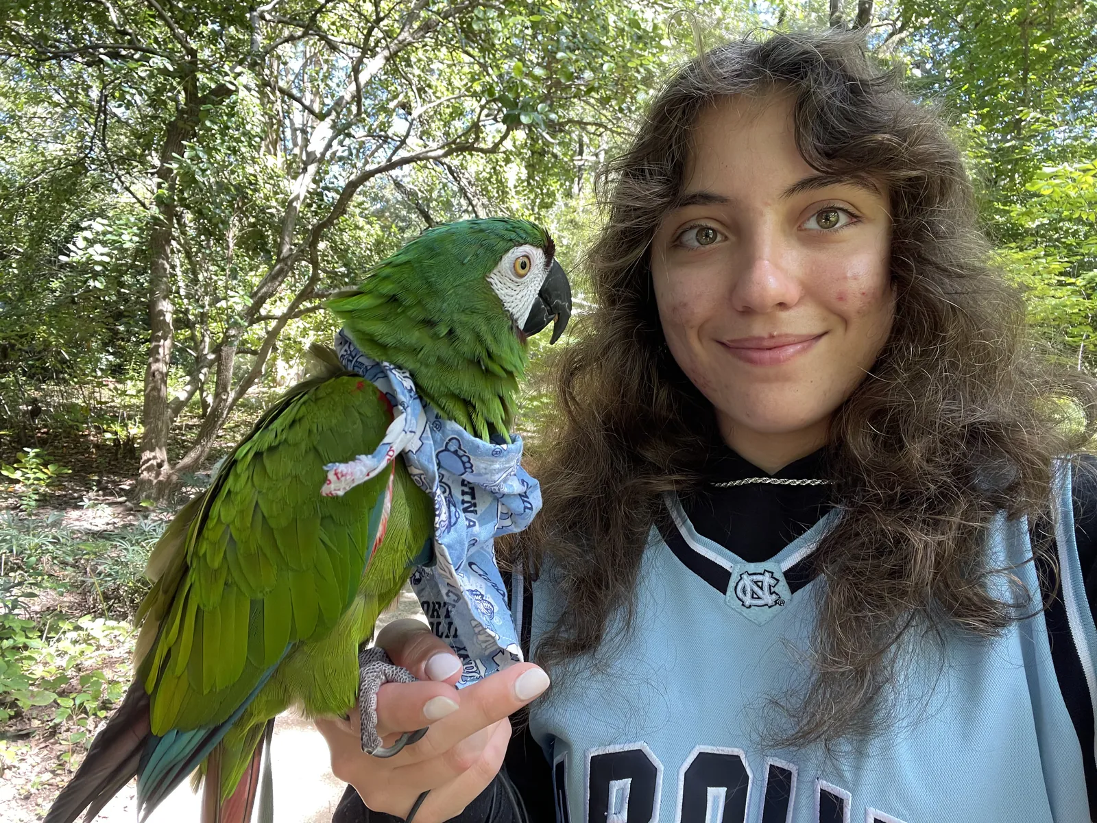 Flor in her Carolina jersey with a parrot